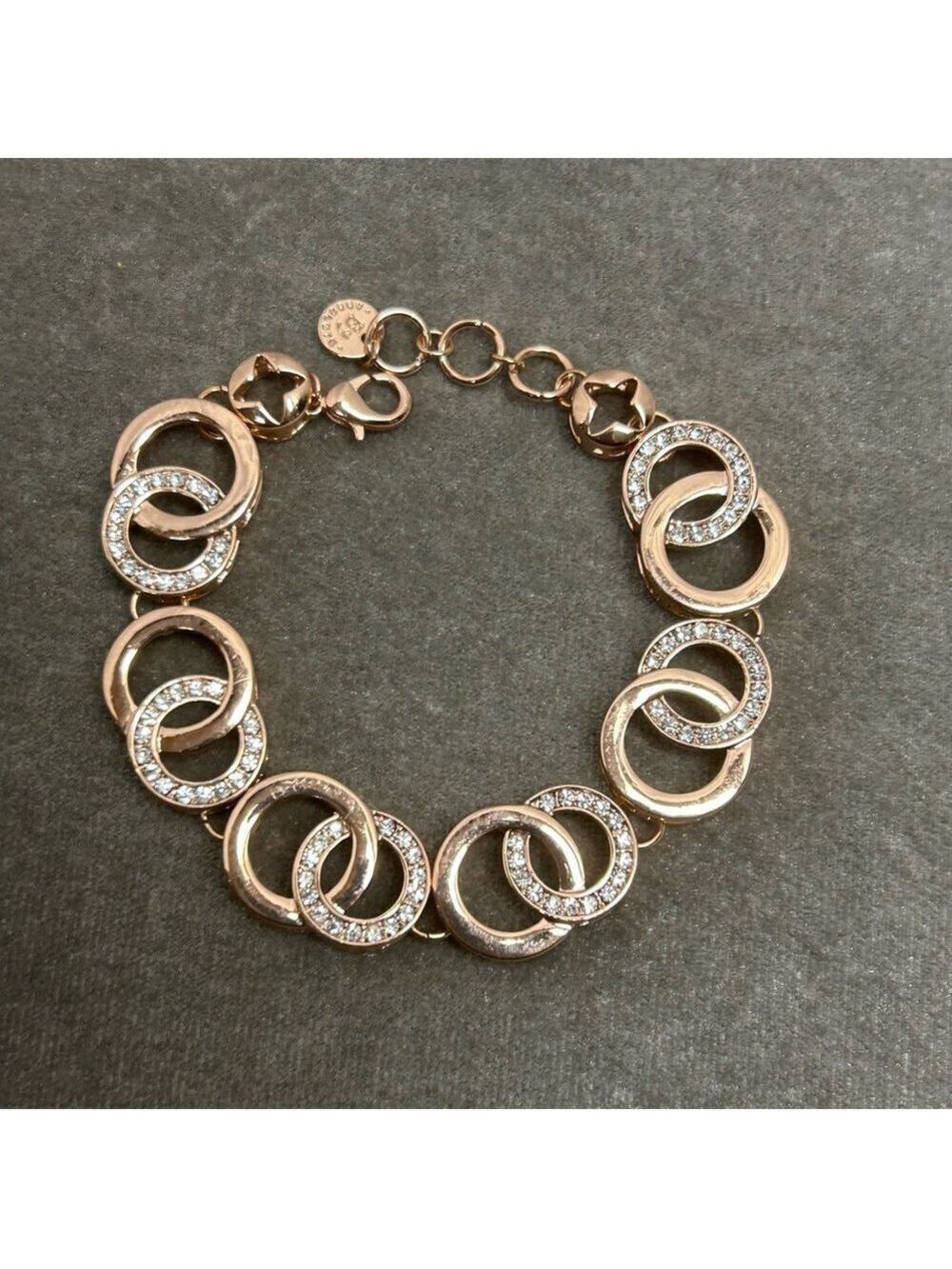 Absolute rose gold tone circular interlocking chain-link rhinestone bracelet